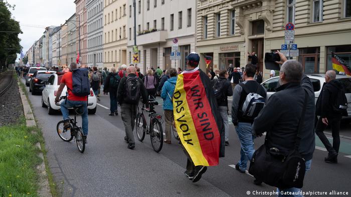 German protesters march through Berlin with German flags and other slogans