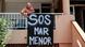 Protester hangs sign against pollution in the Mar Menor lagoon Protester hangs sign against pollution in the Mar Menor lagoon