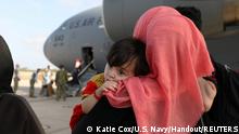 Evacuees from Afghanistan watch others disembark the aircraft after arriving at Naval Station (NAVSTA) Rota, Spain August 27, 2021. Picture taken August 27, 2021. U.S. Navy/Mass Communication Specialist 2nd Class Katie Cox/Handout via REUTERS THIS IMAGE HAS BEEN SUPPLIED BY A THIRD PARTY.