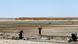 A man stands near a pump in a dry landscape in the province of Raqqa A man stands near a pump in a dry landscape in the province of Raqqa