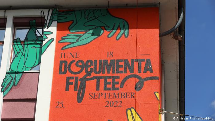 A poster of Documenta Fifteen on a building.