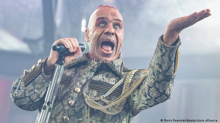 Picture of Rammstein singer Till Lindemann singing while holding a microphone