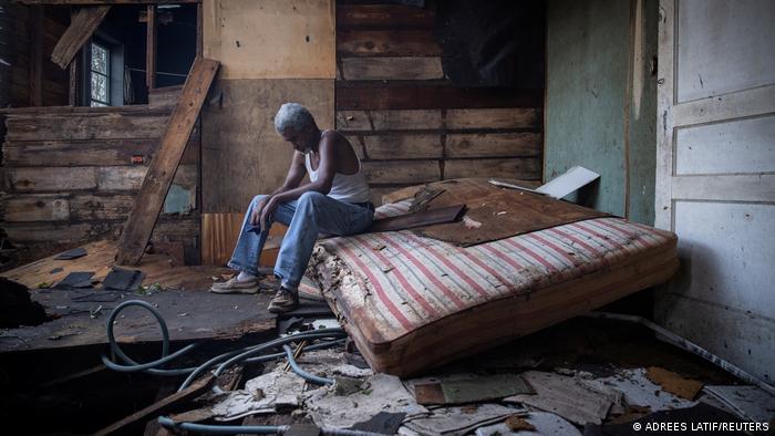 A man sits on a mattress in his badly damaged home in Houma, Louisiana 