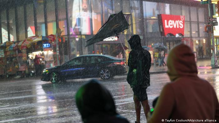 Una persona con un paraguas destruido por la tormenta en el Time Square de Nueva York.