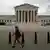 A woman walks by the US Supreme Court in Washington D.C. REUTERS/Tom Brenner
