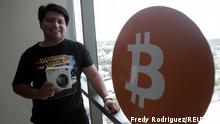 Juan Mayen, 28, chief executive of Honduran firm TGU Consulting Group, poses for a photo with a cryptocurrency hardware wallet at the TGU office where he installed the first cryptocurrency ATM machine in the country that allows users to acquire bitcoin and ethereum using the local lempira currency, in Tegucigalpa, Honduras August 27, 2021. REUTERS/Fredy Rodriguez