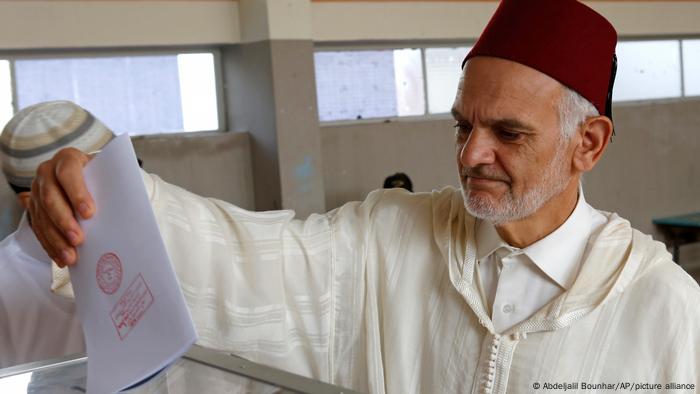  Moroccan man casts his ballot at a polling station for the parliamentary elections, in Rabat.