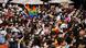 Marchers hold a banner that reads "Ja" in the Pride rainbow colors Marchers hold a banner that reads "Ja" in the Pride rainbow colors