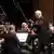 Herbert Blomstadt conducts an orchestra
