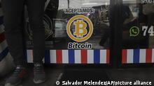 We accept Bitcoin is announced at a barber shop in Santa Tecla, El Salvador, Saturday, Sept. 4, 2021. Starting Tuesday, Sept. 7, all businesses will have to accept payments in Bitcoin, except those lacking the technology to do so. (AP Photo/Salvador Melendez)