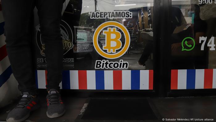 A sign on a window saying that Bitcoin is accepted