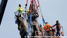 Crews work to remove one of the country's largest remaining monuments to the Confederacy, a towering statue of Confederate General Robert E. Lee on Monument Avenue, Wednesday, Sept. 8, 2021, in Richmond, Va. (AP Photo/Steve Helber, Pool)