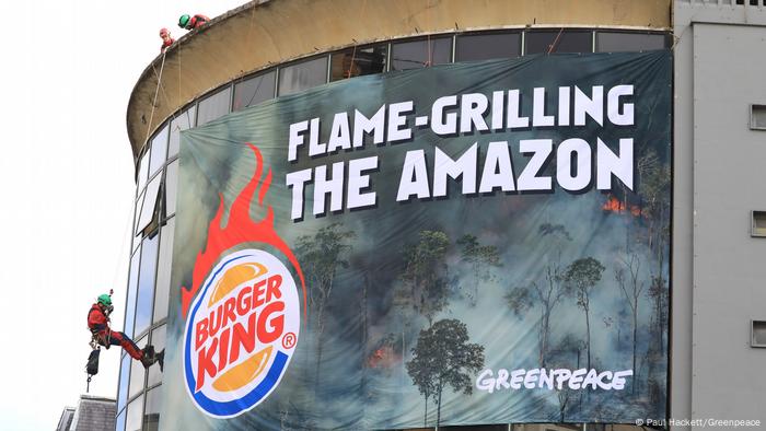 Protest banner on the building of Burger King restaurant in London