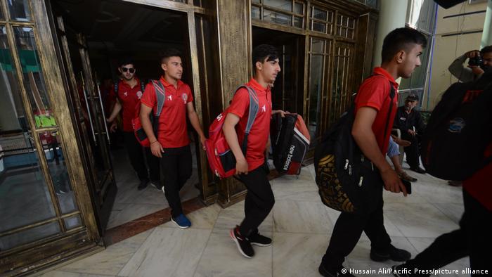Afghanistan cricket team players board a bus from a local hotel 