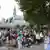 Pilgrims waiting outside the shrine at Lourdes after it was evacuated.