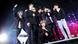 BTS, several young people dressed mainly in black on stage, with microphones BTS, several young people dressed mainly in black on stage, with microphones