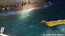 The Italian Coast Guard uses an inflatable raft to rescue migrants stuck on the shore of the Isola dei Conigli island off the Sicilian island of Lampedusa, southern Italy, Thursday, Sept. 9, 2021. The Italian Coast Guard rescued 125 migrants trapped on the rocks due to rough seas. (Italian Coast Guard via AP)