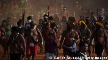 TOPSHOT - Indigenous protesters march during a demonstration to exert pressure ahead of a crucial Supreme Court ruling that could take away their ancestral lands, at a protest camp in Brasilia on September 10, 2021. - Indigenous groups in Brazil accuse Brazilian President Jair Bolsonaro of systematically attacking their rights and trying to open their lands to agribusiness and mining. The verdict, which could affect more than 200 native lands currently being demarcated, according to the Social Environment Institute (ISA), which defends the rights of indigenous people. (Photo by Carl DE SOUZA / AFP) (Photo by CARL DE SOUZA/AFP via Getty Images)