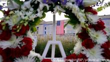 An American flag is unfurled at the Pentagon in Washington, Saturday, Sept. 11, 2021, at sunrise on the morning of the 20th anniversary of the terrorist attacks. The American flag is draped over the site of impact at the Pentagon. In the foreground, the National 9/11 Pentagon Memorial, opened in 2008 adjacent to the site, commemorates the lives lost at the Pentagon and onboard American Airlines Flight 77. (AP Photo/Alex Brandon)