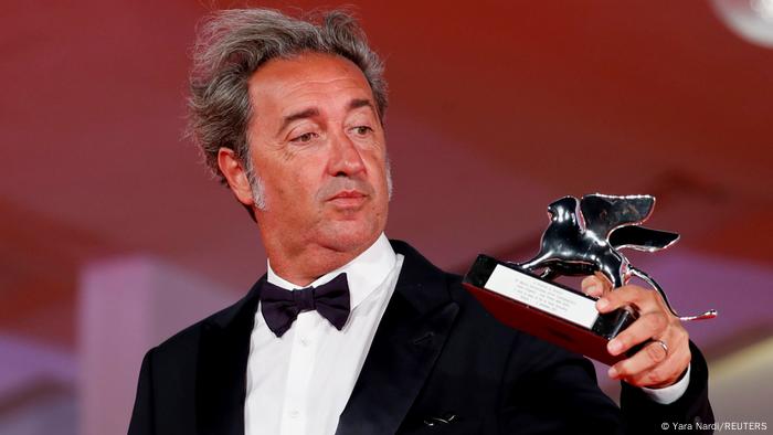 Italian filmmaker Paolo Sorrentino holds up the Silver Lion