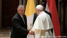 Pope Francis shakes hands with Hungary's Prime Minister Viktor Orban at Romanesque Hall in the Museum of Fine Arts in Budapest, Hungary, September 12, 2021. Vatican Media/­Handout via REUTERS ATTENTION EDITORS - THIS IMAGE WAS PROVIDED BY A THIRD PARTY.