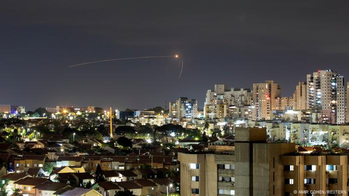 A streek of light is seen in the Ashkelon skyline as Israel's Iron Dome intercepts a rocket launched from the Gaza Strip