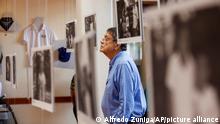 FILE - In this Sept. 30, 2019 file photo, writer Sergio Ramirez looks at a picture during the inauguration of an exhibit of photographs and personal items that belonged to people who have been killed amid anti-government protests in Managua, Nicaragua. Ramírez, winner of the 2017 Cervantes Prize, says there is a “dictatorial injustice” in Nicaragua and calls for international solidarity with opponents imprisoned by the government of President Daniel Ortega. (AP Photo/Alfredo Zuniga, File)