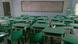 An empty classroom full of green desks and chairs An empty classroom full of green desks and chairs