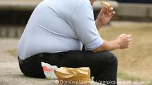 Health minister views on overweight people.An overweight man eats fast food. GPs and other health professionals should tell people they are fat rather than obese, a health minister said today. Picture date: Wednesday July 28, 2010. Anne Milton said the the term fat was more likely to motivate people into losing weight, adding it was important people took "personal responsibility" for their lifestyles. See PA story HEALTH Obesity. Photo credit should read: Dominic Lipinski/PA Wire URN:9237867