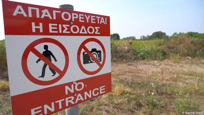 A warning sign in Greek and English indicates that entrance and taking photographs are forbidden 