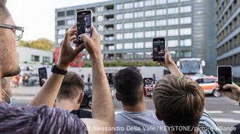 A group of people recording something with their smartphones