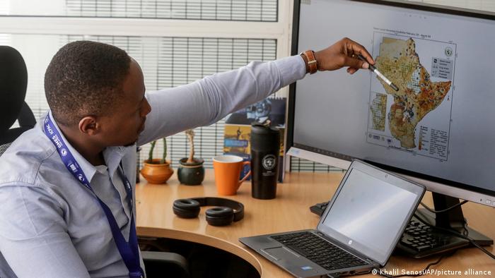 Kenneth Mwangi, a satellite information analyst at the Intergovernmental Authority on Development's Climate Prediction and Applications Center, shows a map predicting the movement of desert locust swarms, in Nairobi, Kenya