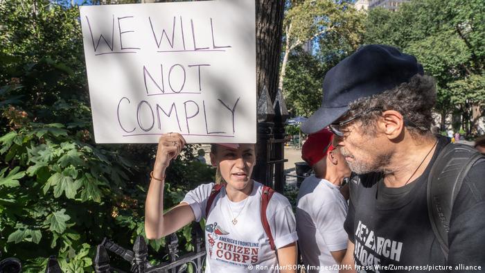 A protester holds a poster that reads We will not comply at a rally in New York City opposing vaccine mandates