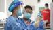 A student waits to receive a dose of COVID-19 vaccine at a vaccination point in China A student waits to receive a dose of COVID-19 vaccine at a vaccination point in China