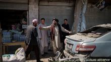 Taliban fighters and residents gather at the site of an explosion in Kabul, Afghanistan, Saturday, Sept. 18, 2021. A sticky bomb exploded in the capital Kabul wounding a few people, said police officials. (AP Photo/Felipe Dana)