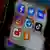 A smart phone screen displays social media platforms' application icons of Facebook, Instagram, Twitter, TikTok, VK, Odnoklassniki, YouTube and Telegram