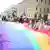 "КиевПрайд" прошел в 2021 году под лозунгом: "Плечом к плечу на защиту равноправия". На фото: участники акции держат "радужный" флаг, символизирующий равенство всех людей и солидарность с ЛГБТ-сообществом