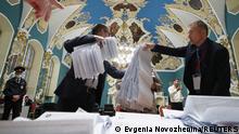 Members of a local election commission count ballots at a polling station inside Kazansky railway terminal after polls closed during a three-day long parliamentary election in Moscow, Russia September 19, 2021. REUTERS/Evgenia Novozhenina