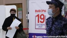 A woman walks to cast her ballot at a polling station on the last day of three-day long parliamentary elections in Moscow, Russia September 19, 2021. REUTERS/Evgenia Novozhenina