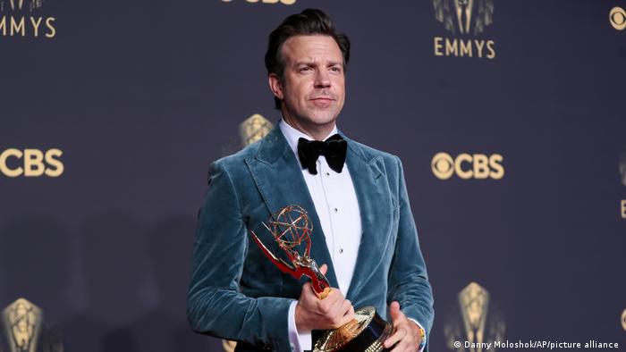Jason Sudeikis holding an Emmy Award in 2021.