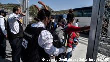 A refugee is being screened by a private security member with a metal detector before entering the new Samos RIC, the first of five new 'closed' migrant camps, on the island of Samos, Greece, on September 20, 2021. - Greece began on September 20, 2021, moving asylum seekers to the first of several new EU-funded closed camps on its islands, only accessible via electronic chip, hours after a fire torched a part of the current facility. The EU has committed 276 million euros ($326 million) for the new camps on Greece's five Aegean islands - Leros, Lesbos, Kos, Chios as well Samos - that receive most of the migrant arrivals by sea from neighbouring Turkey. (Photo by LOUISA GOULIAMAKI / AFP) (Photo by LOUISA GOULIAMAKI/AFP via Getty Images)