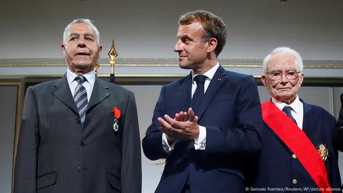 three men standing in suits three men standing in suits