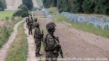 Defence minister Mariusz Blaszczak said more soldiers would be sent and a fence 2.5 metres tall would be erected along most of the 150-kilometre border, with construction due to begin next week. Polish army soldier in front of border between Poland and Belarus. On August 26, 2021 at Border Poland-Belarus. (Photo by Maciej Moskwa/NurPhoto)