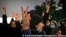 People gesture while listening to a speaker during a protest against the results of the Parliamentary election in Moscow, Russia, Monday, Sept. 20, 2021. The results in the other six regions that were allowed to vote online have been detailed. In Moscow, approval of the ruling party has always been particularly low and protest voting has been widespread. Candidates from the Communist Party called for demonstrations later in the day. (AP Photo/Pavel Golovkin)