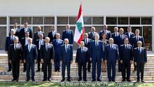 In this photo released by Lebanese government, members of the new government pose for an official picture at the Presidential Palace in Baabda, east of Beirut, Lebanon, Monday, Sept 13, 2021. Front row from left to right are Defense Minister Maurice Slim, Interior Minister Bassam Mawlawi, Deputy Prime Minister Saadeh Shami, Parliament Speaker Nabih Berri, President Michel Aoun, Prime Minister Najib Mikati, Foreign Minister Abdullah Bouhabib, Information Minister George Kordahi, Minister of Youth and Sports George Kallas. (Dalati Nohra/Lebanese Official Government via AP)