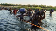 Haitian migrants continue to cross across the US-Mexico border on the Rio Grande as seen from Ciudad Acuna, Coahuila state, Mexico on September 20, 2021. - Migrant families sent back to Haiti by the United States after attempting to enter the country from Mexico are angry at their treatment and fearful of returning back home to a life punctuated by gang violence. The deportation of Haitian migrants had been temporarily suspended by Washington after a devastating earthquake hit the Caribbean nation last month.But in recent days, more than 15,000 Haitians crossed into the country from Mexico and found themselves stranded for days in Texas under a bridge spanning the Rio Grande river, blocked from moving onwards. (Photo by PAUL RATJE / AFP) (Photo by PAUL RATJE/AFP via Getty Images)