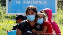 Central American migrants stand at the Mexico - Guatemala border after they were expelled by U.S. and Mexican officials, in El Ceibo, Guatemala August 15, 2021. The sign reads Limit of the Republic of Guatemala. Picture taken August 15, 2021. REUTERS/Luis Echeverria