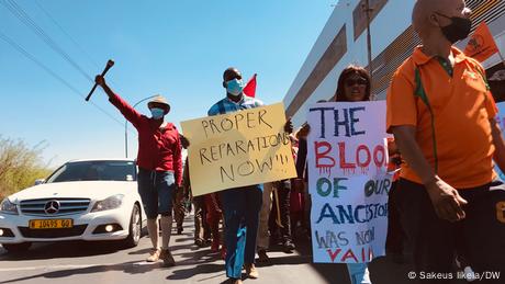 A group of men and women holding placards