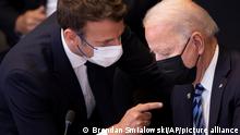 U.S. President Joe Biden, right, speaks with French President Emmanuel Macron during a plenary session during a NATO summit at NATO headquarters in Brussels, Monday, June 14, 2021. U.S. President Joe Biden is taking part in his first NATO summit, where the 30-nation alliance hopes to reaffirm its unity and discuss increasingly tense relations with China and Russia, as the organization pulls its troops out after 18 years in Afghanistan. (Brendan Smialowski, Pool via AP)
