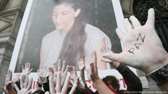 Demonstrators hold a poster of Ingrid Betancourt 